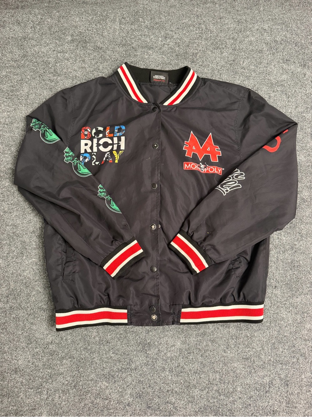 Black Monopoly Graphic Varsity Bomber Jacket with Red Trim